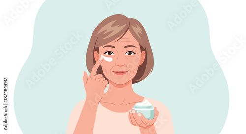 Mature woman applying moisturizing cream to her face for skincare and anti-aging