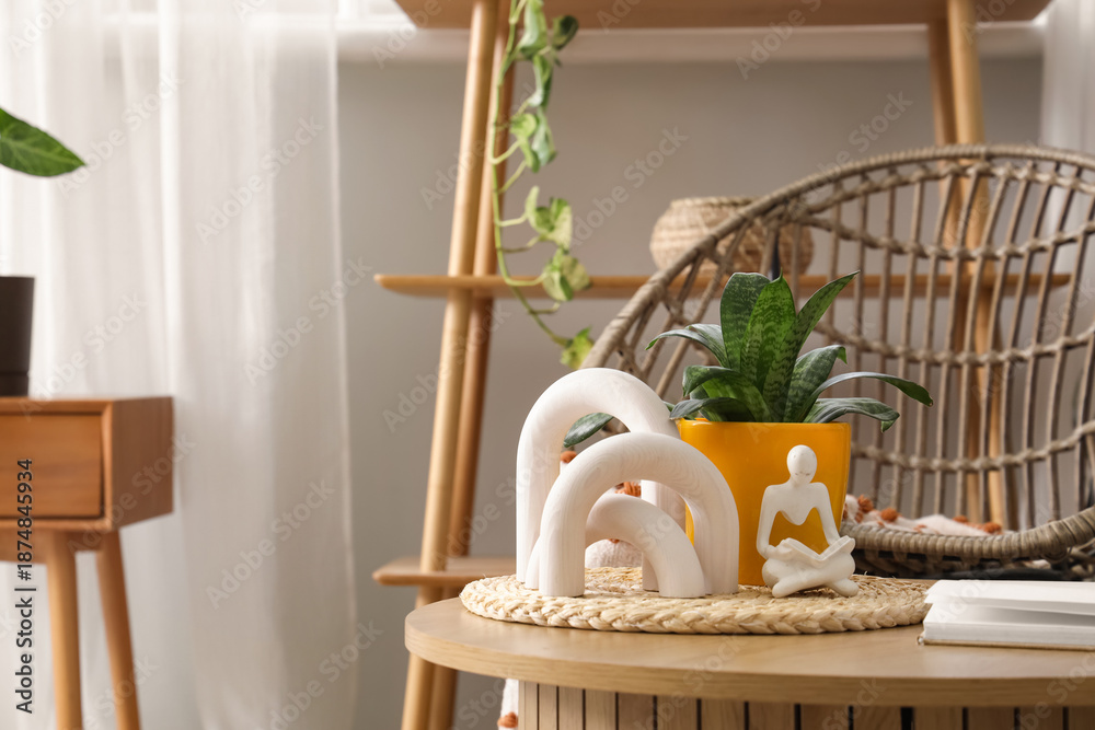 Obraz premium Plant with stylish decor on wooden table in living room