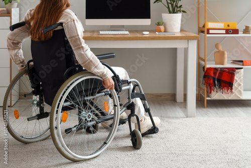 Woman in wheelchair near de...