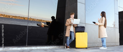 Young couple with luggage u...