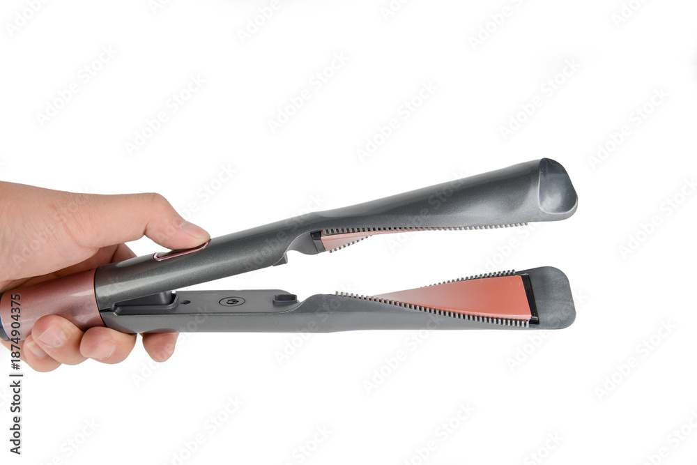 Fototapeta premium One hand holding a straightening iron