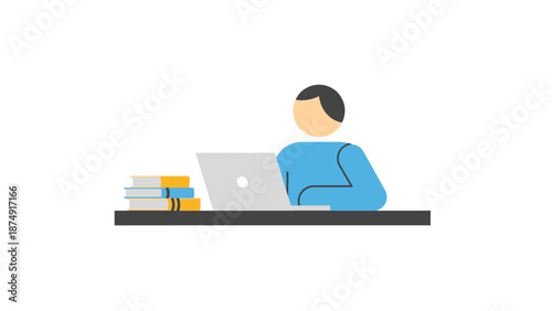 A person working on a laptop with books nearby on a desk viewed from the side