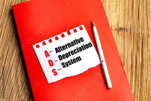 Quadro su tela Alternative depreciation system acronym written on paper with red notebook and p