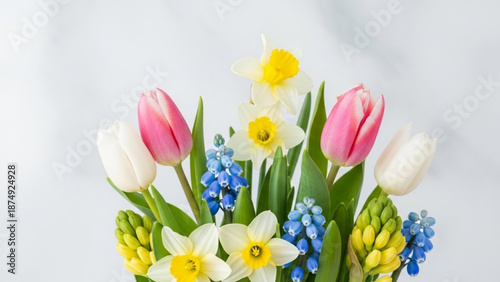 Vibrant spring bouquet with tulips daffodils and blue flowers