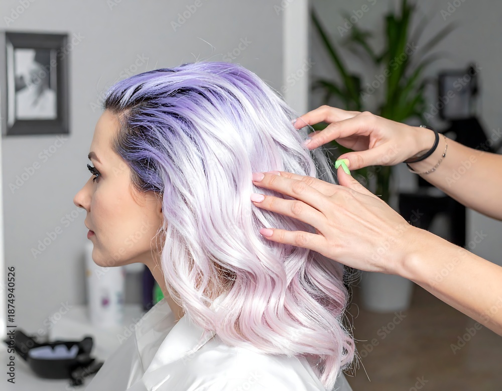 Fototapeta premium A woman's hair being styled with purple and pink dye