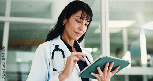 Fotografie Woman, doctor and reading with tablet in hospital for research, medical report and confirm surgery