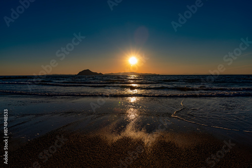 干潟の海岸に沈む夕日
