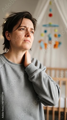 Female Adult with Neck Pain in a Cozy Nursery Setting Near a Mobile