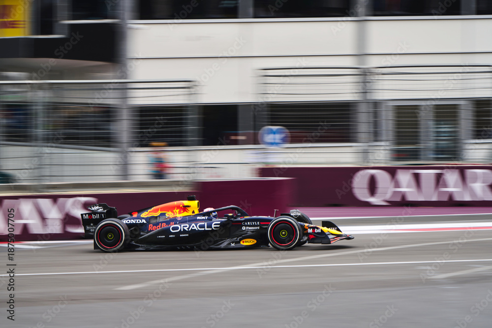 Naklejka premium BAKU, AZERBAIJAN - SEPTEMBER 21, 2025: A high-speed action shot of the Oracle Red Bull Racing Formula 1 car driving past the Qatar Airways signage during the Azerbaijan Grand Prix
