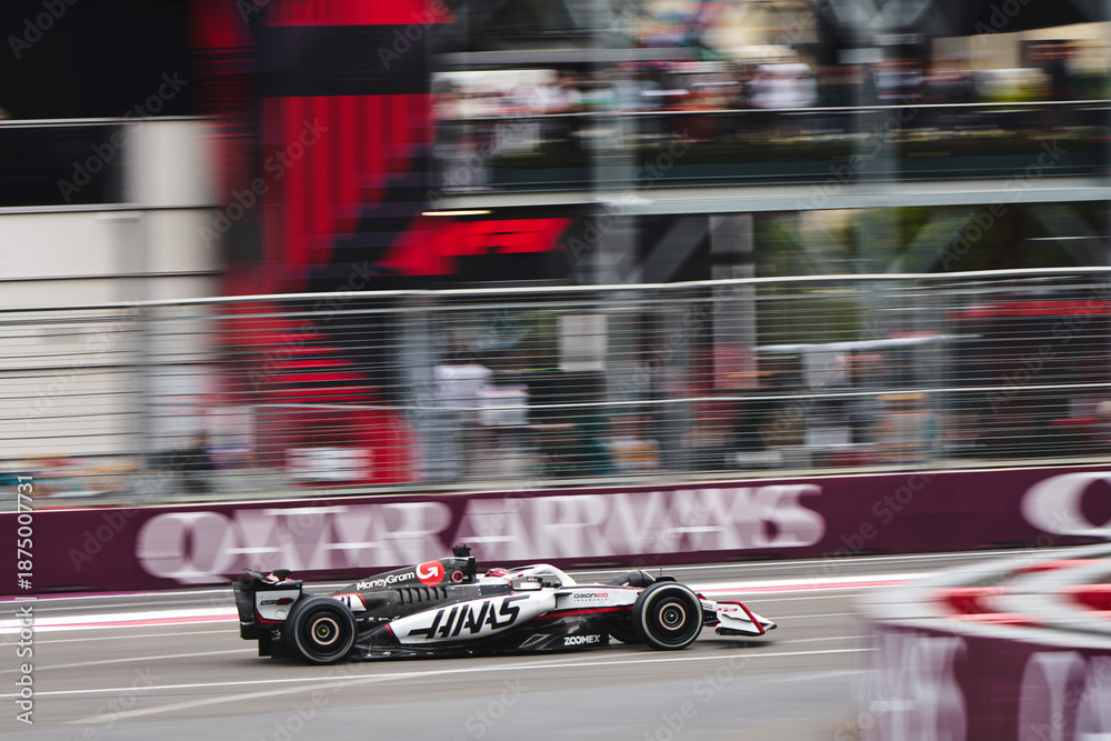 Naklejka premium BAKU, AZERBAIJAN - SEPTEMBER 21, 2025: Esteban Ocon speeds along the Baku City Circuit in his MoneyGram Haas F1 Team car during the Formula 1 Azerbaijan Grand Prix