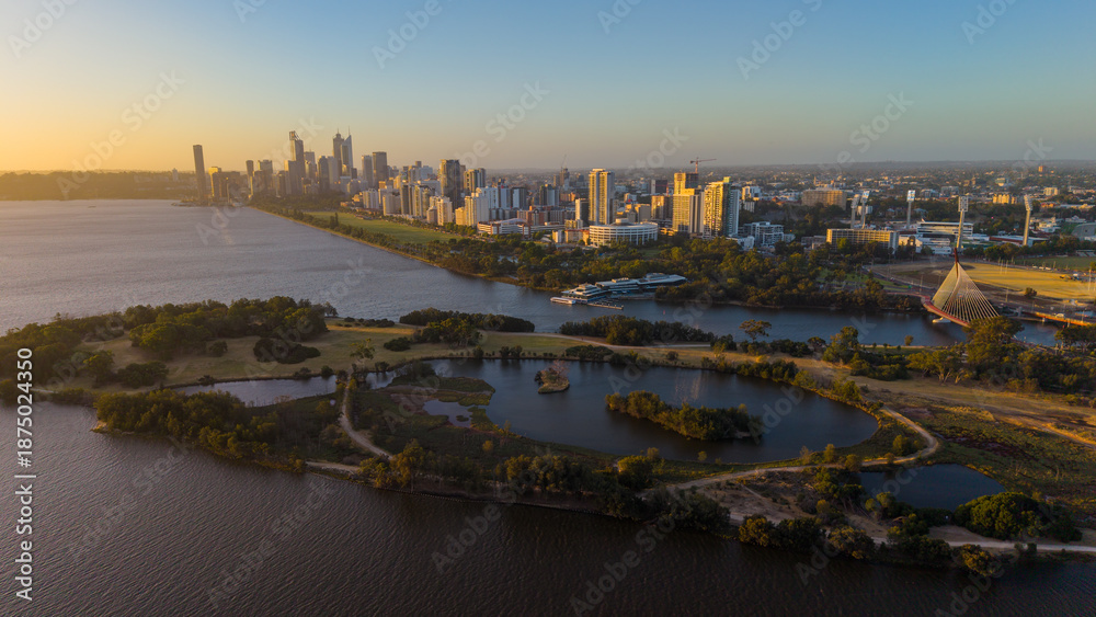 Naklejka premium Aerial view of Perth city skyline with Boorloo bridge lit up connecting Heirisson island with walking and cycling path along the Swan river