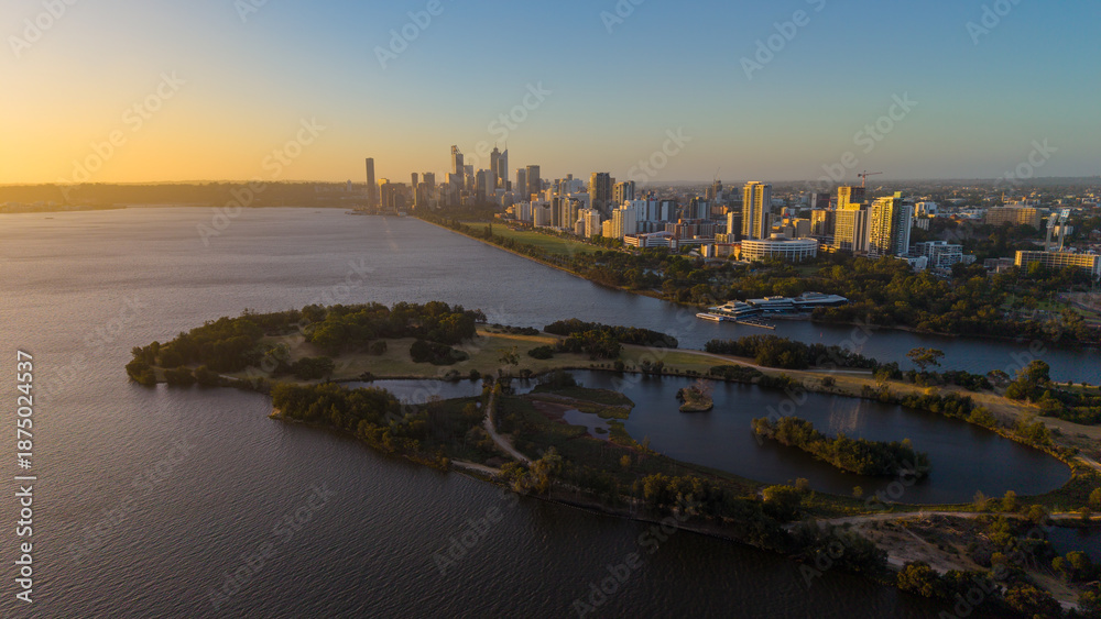 Naklejka premium Aerial view of Perth city skyline with Boorloo bridge lit up connecting Heirisson island with walking and cycling path along the Swan river