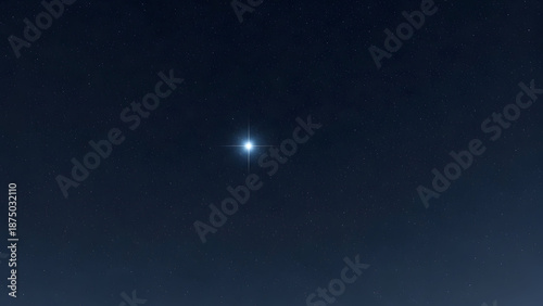 Bright star shining in dark night sky with many stars