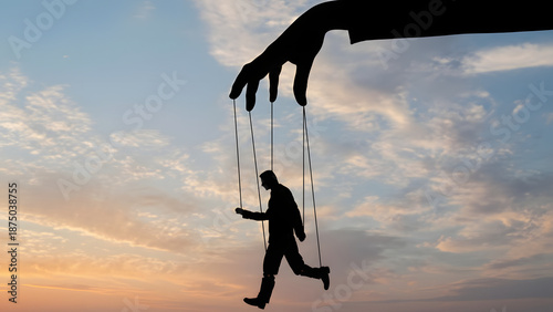 A silhouette of a giant hand manipulating a human puppet with strings against a dramatic sunset sky, symbolizing control and power.
