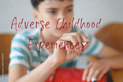 ADVERSE CHILDHOOD EXPERIENCES. Childhood and adolescence. Preteen child writing text on the screen with a red marker.