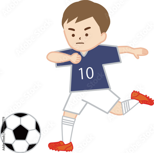 サッカーの試合でシュートをする男の子