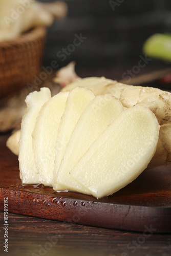 Canvas Print Fresh Sliced Ginger Root with Tender Buds on Wooden Board