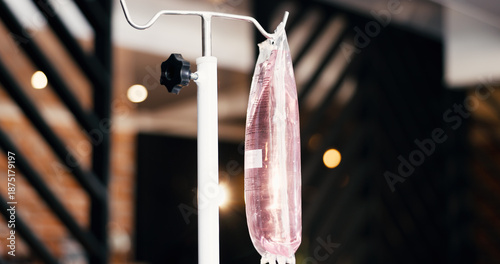 Therapy, IV bag and drip in lounge for health benefits, saline solution and immune system boost. Bokeh, intravenous infusion and medical fluid at wellness center for nutrition, detox and electrolytes
