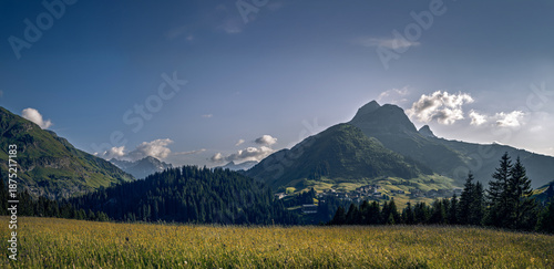 View from Lechleiten towards Warth and Karhorn, late summer alpine meadows, calm wind, stunning panorama of the Tyrolean Alps, Austria.