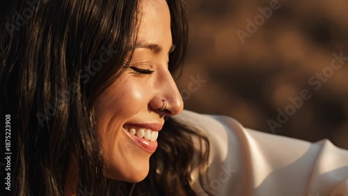 woman with nose ring smiling in sunlight