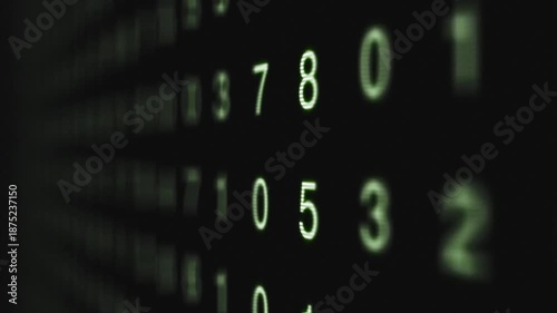 Close-up of green numbers on a black background with a shallow depth of field conveying a technological and data-driven mood.