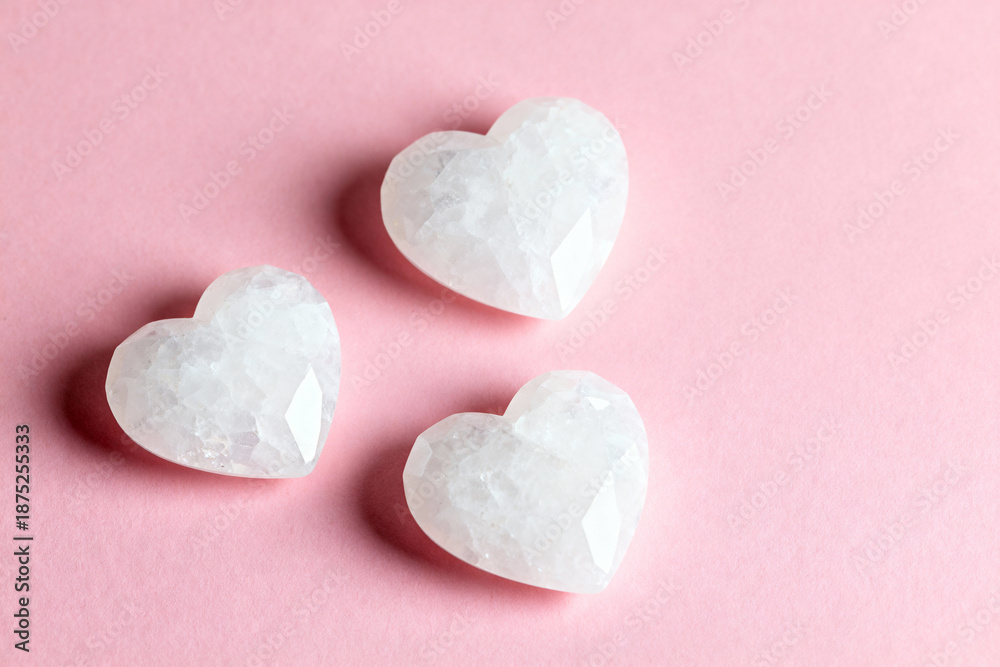 Fototapeta premium White cristal shaped hearts, on a soft pink background. Valentin's Day.