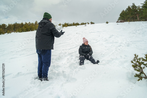People playing in snow enjoying winter outdoor activity