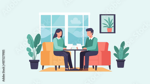 Two people sit across from each other at a small table between two couches in a room