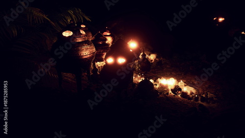 Foto Soft lights flicker from ornate pots, illuminating the dark surroundings with a warm glow