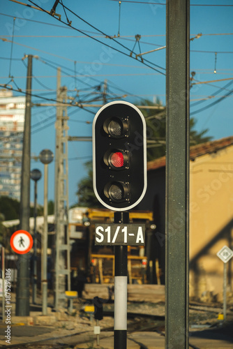 Railway Traffic Signal showing Red Stop Light under Blue Sky