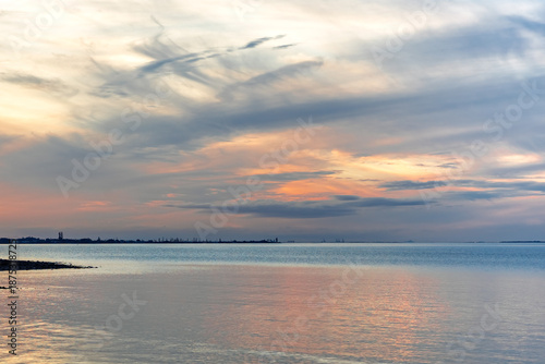 Beautiful dramatic cloudy sunset sky over the sea. View toward Cleveland Point, from Morwong Beach, Coochiemudlo Island, Queensland, Australia 