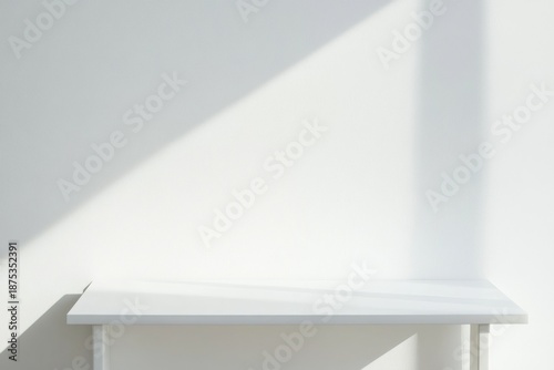 Wallpaper Mural White table against white wall background with shadows creating a simple scene during daylight in an indoor setting Torontodigital.ca
