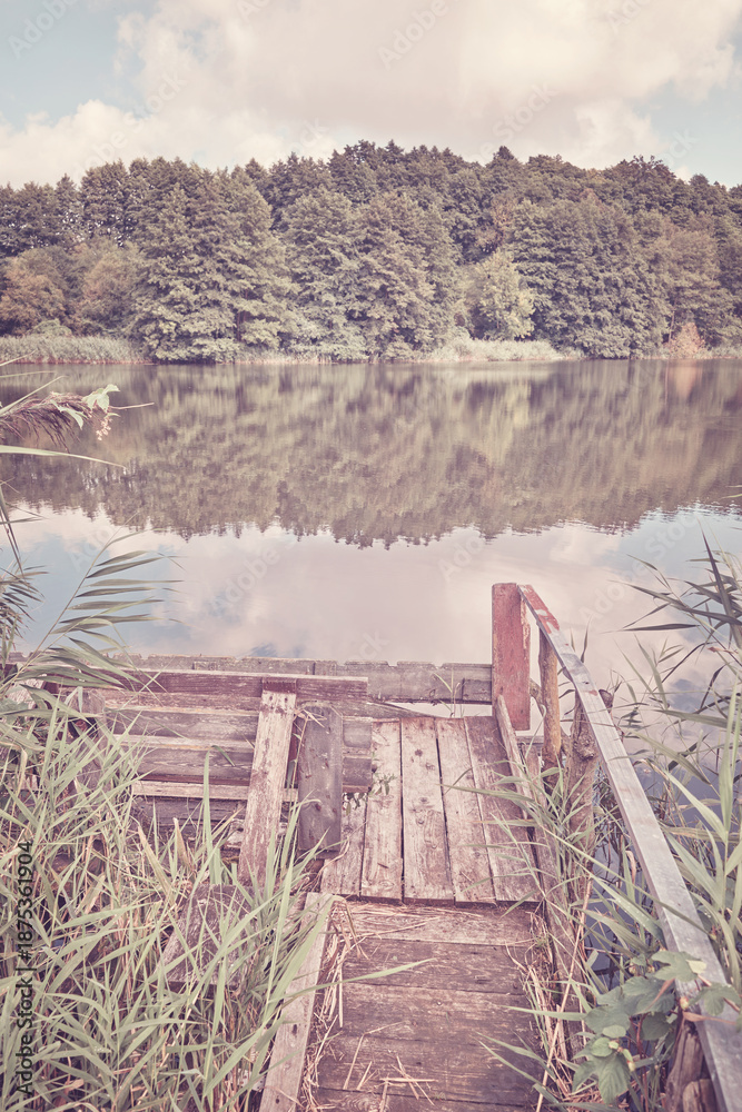 Fototapeta premium A small fishing pier by the lake, color toning applied.