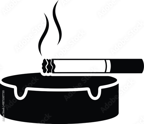 Cigarette resting on ashtray with smoke rising