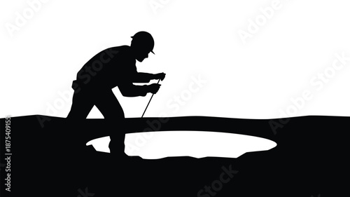 Silhouette of worker digging hole in ground with shovel