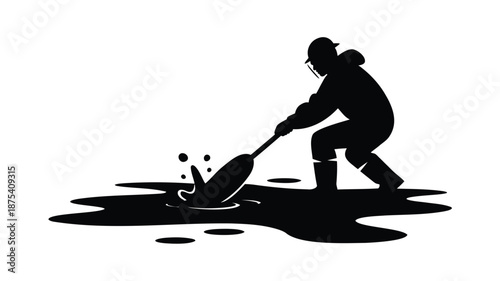 Worker in protective gear cleaning up oil spill with shovel