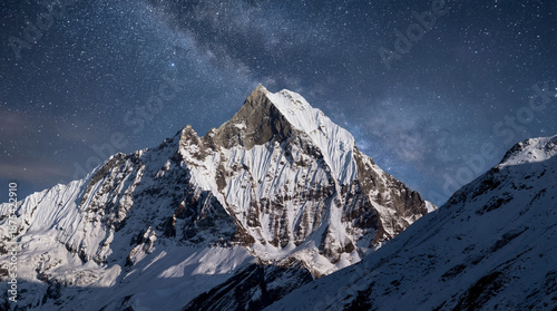 Fotografi Starry night sky above a snow covered Himalayan mountain peak
