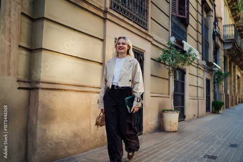 Wallpaper Mural Happy woman walking with digital tablet in hand, smiling confidently. Represents professional mobility, personal style, and empowered freelance tech routine Torontodigital.ca