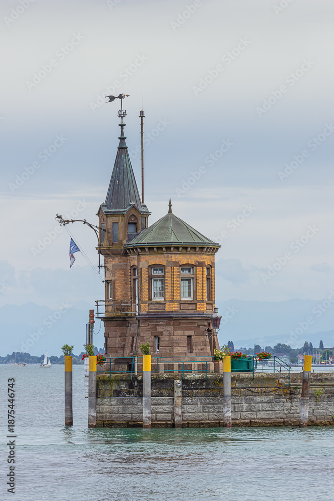 Fototapeta premium The guard tower at the entrance of the harbor of Konstanz with the Alps in the background