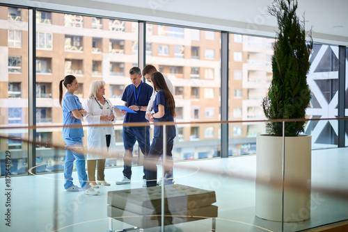 Tablou pe pânză Healthcare team collaborates on patient care strategies in modern medical facili