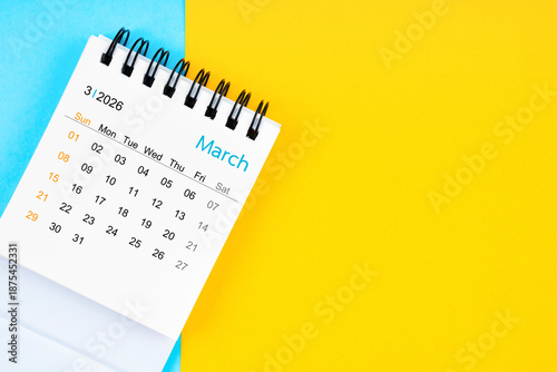 March 2026, Monthly desk calendar for 2026 year on yellow and blue background.