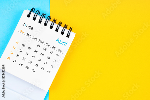 April 2026, Monthly desk calendar for 2026 year on yellow and blue background.