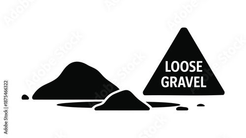 Warning sign for loose gravel on road with mounds of gravel