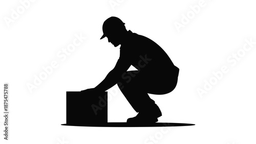 Man crouching down to lift a heavy box with effort