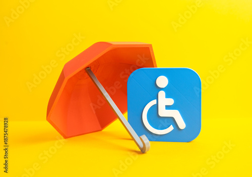 Foto Red umbrella and symbol of a person with a disability