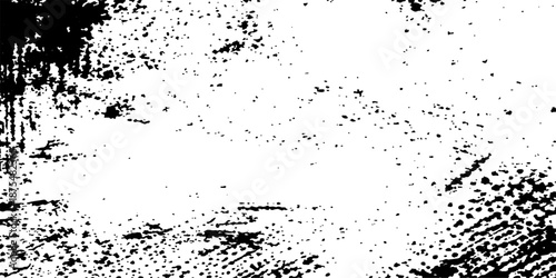 An abstract black and white grunge background featuring a dark ink splash texture with paint splatter art and liquid spray stains on a dirty vector wallpaper element