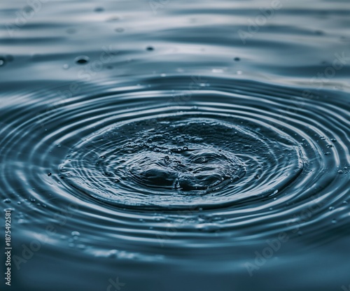 Abstract water surface texture with soft ripples expanding across dark blue liquid, tranquil atmosphere commonly used for spa, mindfulness, and calm visual concepts.