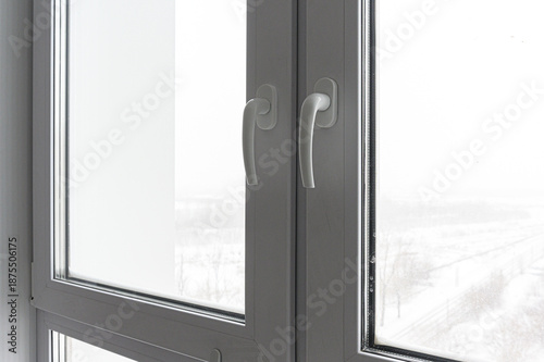 pair of white PVC windows with sleek, ergonomic handles. The frosted glass panels offer privacy while letting in natural light. The frames are smooth, modern, and tightly sealed.