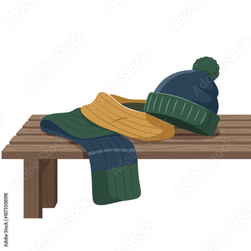 Warm knitted hat and scarf in green and yellow on bench