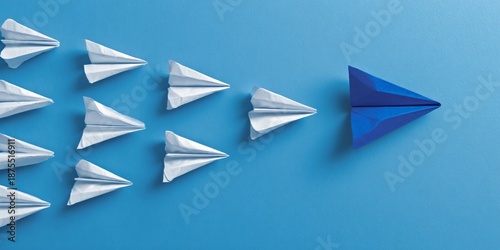 White paper airplanes follow the different blue origami leader plane, representing innovative solution, forward change, and strategic growth for buyers